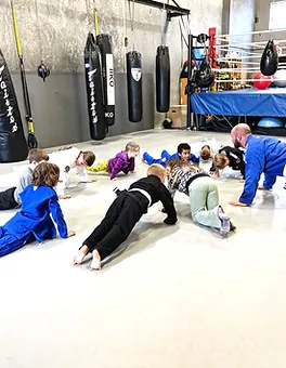Kids practising drills together during the children's martial arts program at Mission BJJ